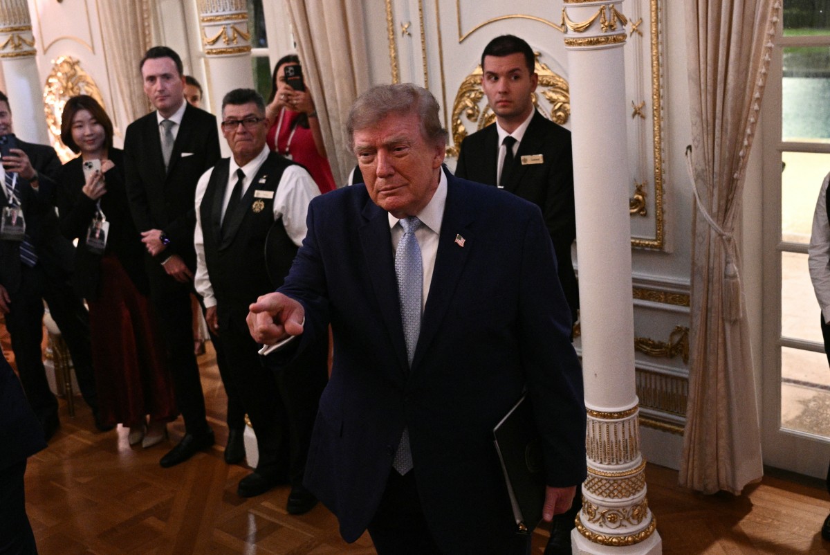 US President Donald Trump point to a supporter during a MAGA Inc. event at his Mar-A-Lago resort in Palm Beach, Florida on October 16, 2026. (Photo by Brendan SMIALOWSKI / AFP)